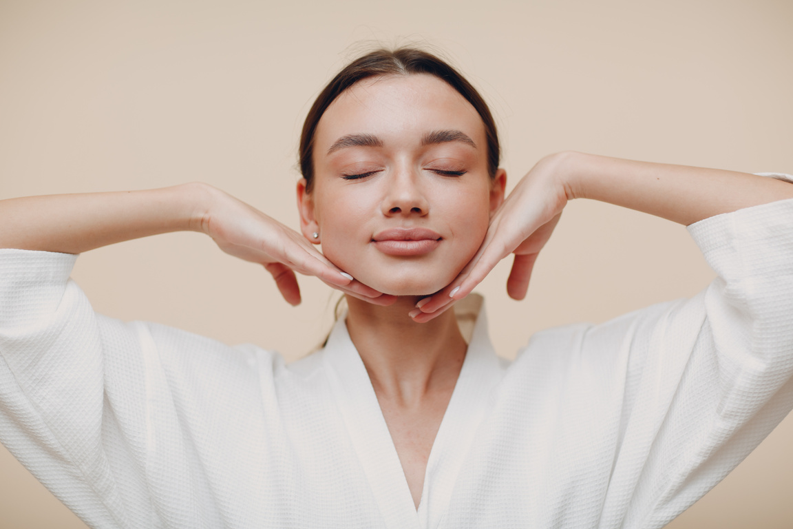 Young Woman Doing Face Building Yoga Facial Gymnastics Self Massage and Rejuvenating Exercises